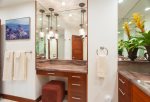 His-and-her vanities with custom cabinets and granite countertops